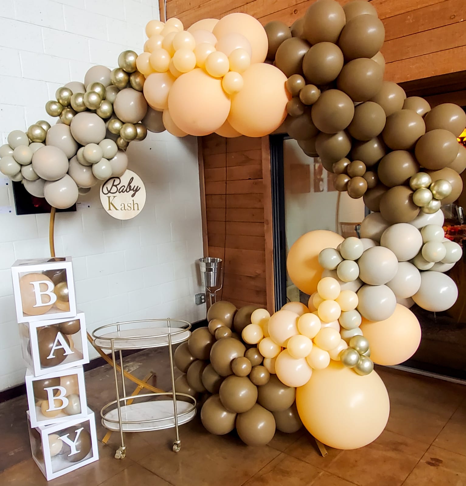 A stunning balloon garland in pastel colors, beautifully adorning a baby shower venue, creating a whimsical and celebratory atmosphere for the occasion.