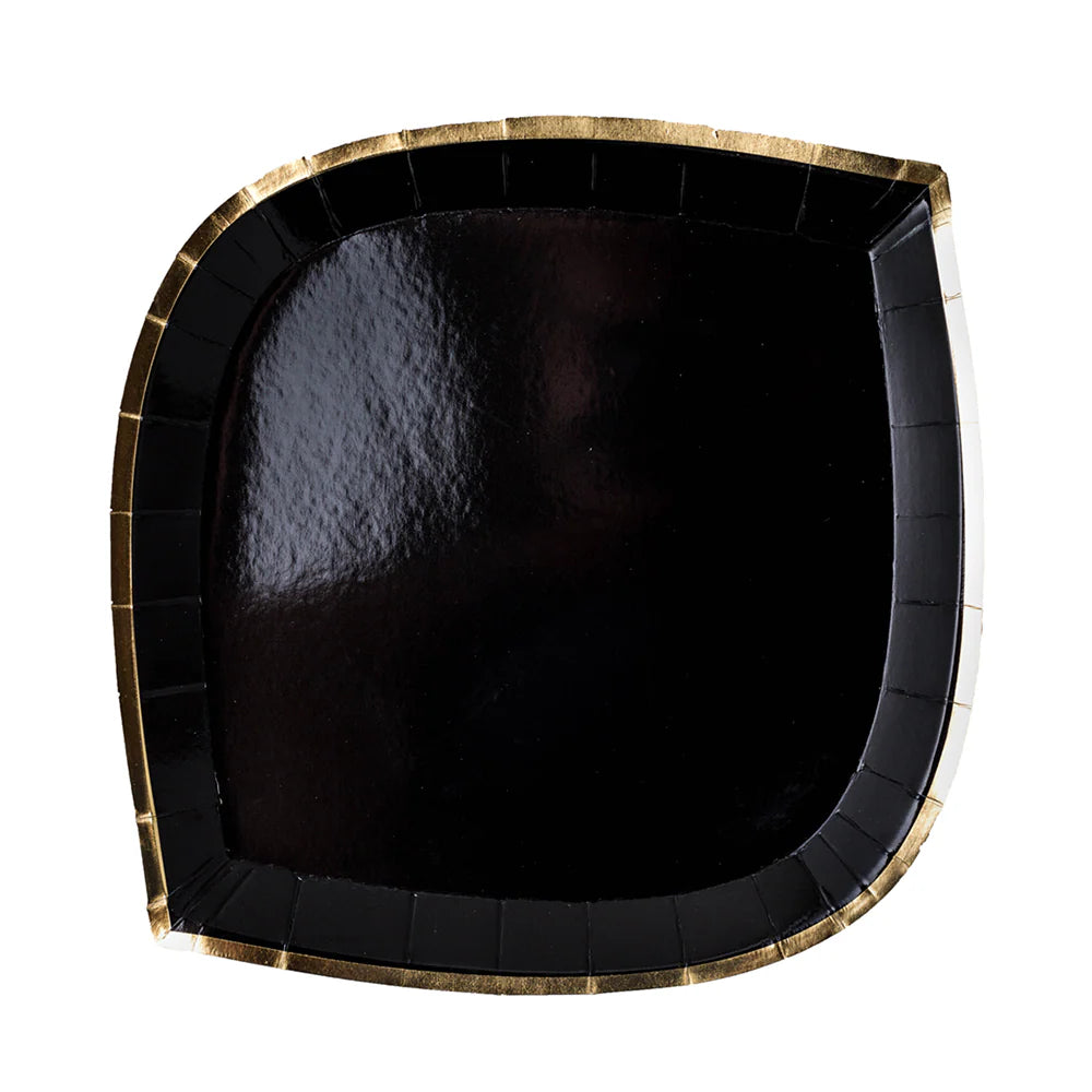 Black paper plate with gold rim on a white background