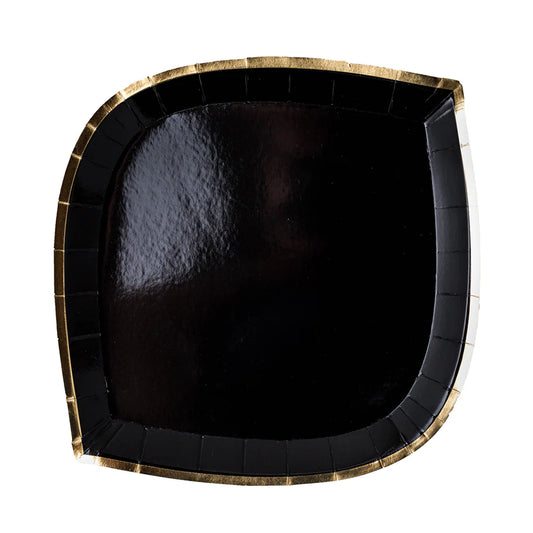 Black paper plate with gold rim on a white background